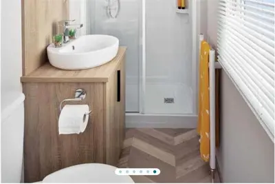 a bathroom with a white sink and a toilet at Two bedroom Holiday home in Newquay