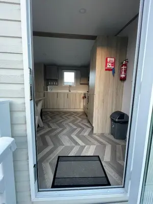an empty room with a door open to a house at Two bedroom Holiday home in Newquay