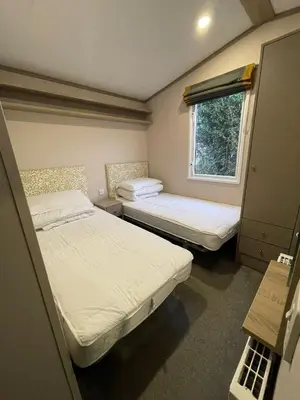 two beds in a small room with a window at Two bedroom Holiday home in Newquay