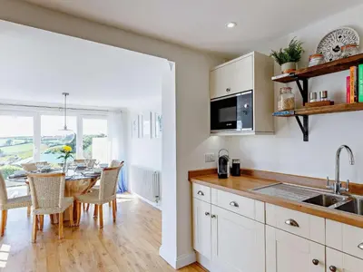 a kitchen with a table and a dining room at 3 Bed in Truro oc-81488 in Saint Just in Roseland