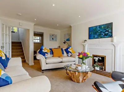 a living room with two couches and a fireplace at 3 Bed in Truro oc-81488 in Saint Just in Roseland