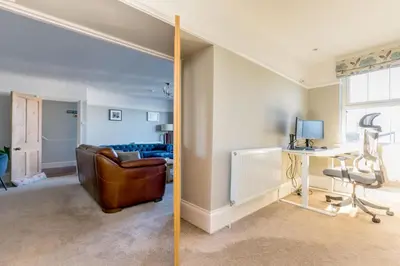 a living room with a couch and a desk at Tre Lowen in Port Isaac