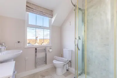 a bathroom with a toilet and a sink and a shower at Tre Lowen in Port Isaac