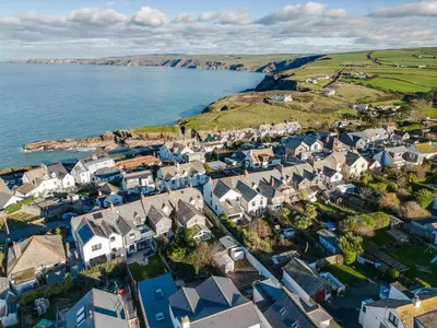 an aerial view of a village next to the ocean at Tre Lowen in Port Isaac