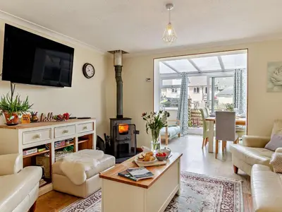 a living room with a couch and a fire place at 3 Bed in Truro oc-78090 in Porthtowan