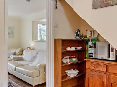 a living room with a couch and a chair at 3 Bed in Truro oc-78090 in Porthtowan