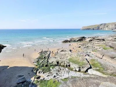 a group of people on a beach near the ocean at 2 Bed in Camelford oc-81245 in Camelford