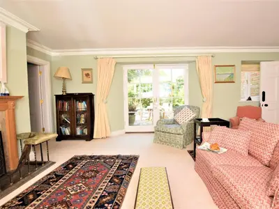 a living room with a couch and a chair at 4 Bed in Truro oc-75546 in Ladock