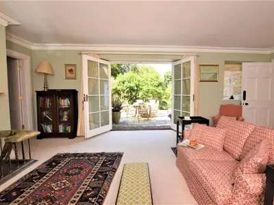 a living room with a couch and an open door at 4 Bed in Truro oc-75546 in Ladock