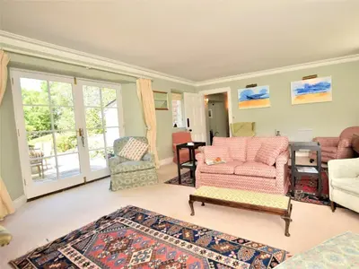 a living room with a couch and a chair at 4 Bed in Truro oc-75546 in Ladock