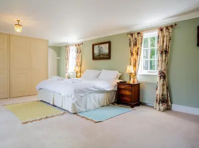 a bedroom with a white bed and a window at 4 Bed in Truro oc-75546 in Ladock