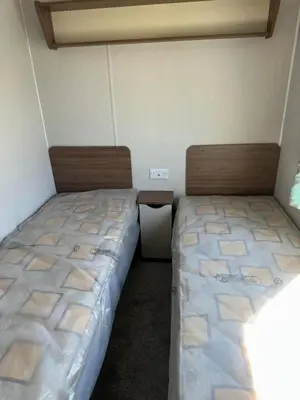 two beds sitting next to each other in a room at Perranporth Beach 3 Bed Holiday Home Cornwall. in Perranporth