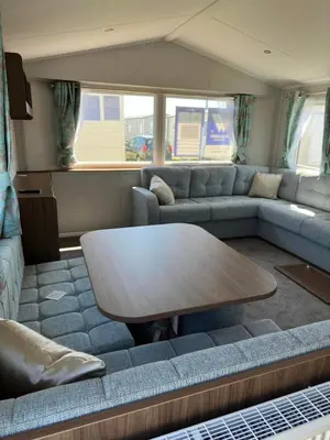 a living room with a couch and a table at Perranporth Beach 3 Bed Holiday Home Cornwall. in Perranporth