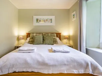 a bedroom with a white bed with two pillows at 4 Bed in Lostwithiel oc-51028 in Lerryn