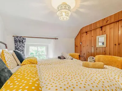a bedroom with a large bed with yellow polka dots at 2 Bed in St. Agnes oc-72422 in St. Agnes