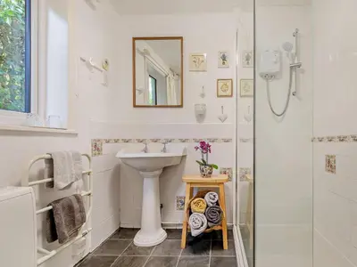 a white bathroom with a sink and a shower at 2 Bed in St. Agnes oc-72422 in St. Agnes