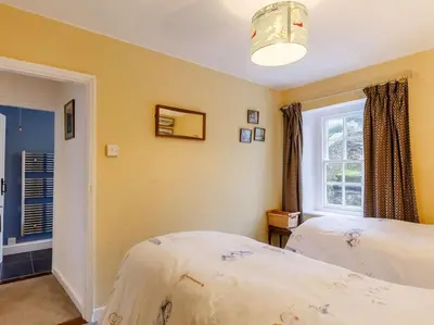 a bedroom with two beds and a window at 2 Bed in Fowey oc-76624 in Fowey