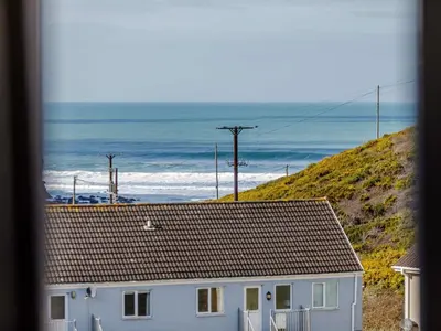 a white house with a view of the ocean at 2 Bed in Truro oc-86648 in Porthtowan