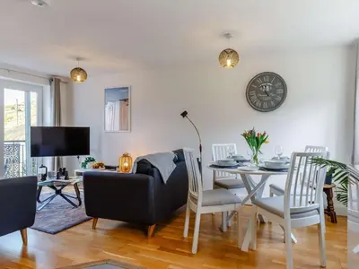 a living room with a table and a couch at 2 Bed in Truro oc-86648 in Porthtowan