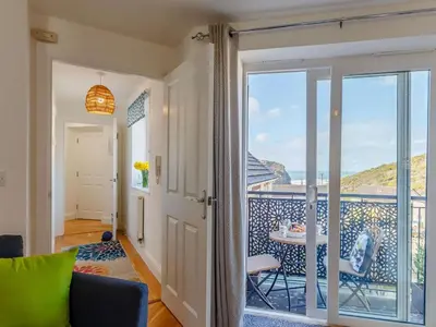 a living room with a door open to a balcony at 2 Bed in Truro oc-86648 in Porthtowan