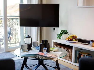 a living room with a table with a tv on it at 2 Bed in Truro oc-86648 in Porthtowan