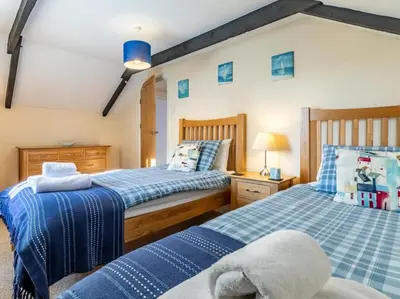 two beds sitting next to each other in a bedroom at 2 Bed in Helston oc-41378 in Cury