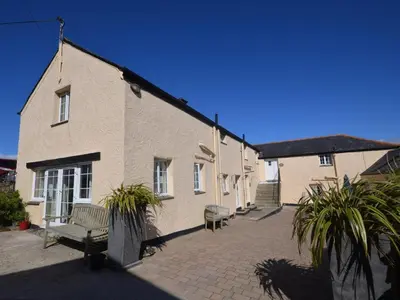 a building with a bench in front of it at 2 Bed in Helston oc-41378 in Cury
