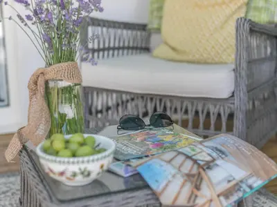 a table with a bowl of apples and a vase at 1 Bed in Bude oc-53410 in Saint Gennys