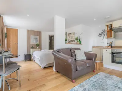 a living room with a couch and a bed at 1 Bed in Bude oc-53410 in Saint Gennys