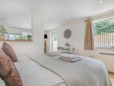 a white bed with towels on it in a bedroom at 1 Bed in Bude oc-53410 in Saint Gennys