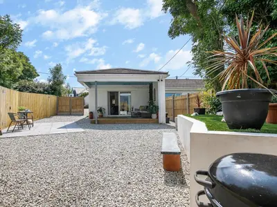 a backyard with a gravel patio and a fence at 1 Bed in Bude oc-53410 in Saint Gennys