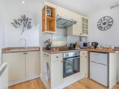 a kitchen with white cabinets and a sink at 1 Bed in Bude oc-53410 in Saint Gennys