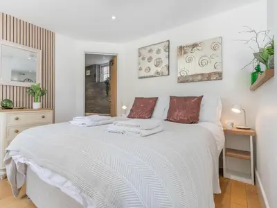 a bedroom with a white bed with towels on it at 1 Bed in Bude oc-53410 in Saint Gennys