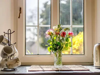 a vase of flowers sitting on a table near a window at 2 Bed in Launceston oc-85912 in Trewen