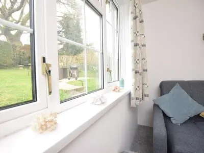 a window seat in a room with a chair and a window at 2 Bed in Launceston oc-85912 in Trewen