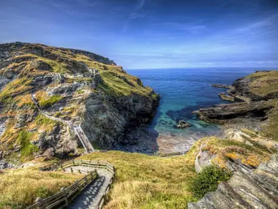 a staircase on the side of a cliff next to the ocean at 2 Bed in Launceston oc-85912 in Trewen
