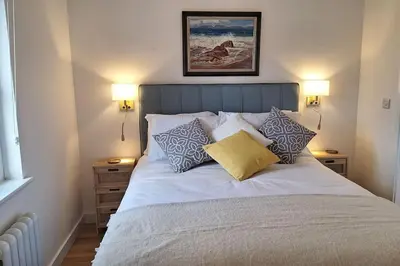 a bed with pillows on it in a bedroom at Rural Cornish Cottage in Truro