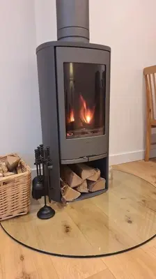 a fireplace in a living room with a fire in it at Rural Cornish Cottage in Truro