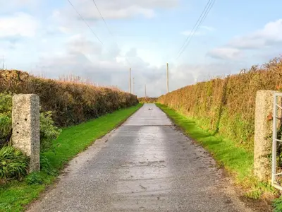 an empty road in a field with grass at 1 Bed in Helston oc-bbird in Saint Martin