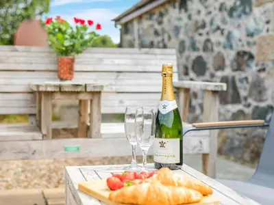 a bottle of champagne and glasses on a table at 1 Bed in Helston oc-bbird in Saint Martin