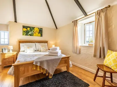 a bedroom with a bed and a window at 1 Bed in Helston oc-41381 in Cury