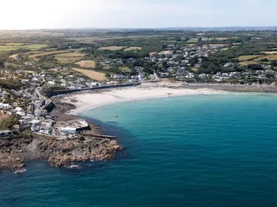 an aerial view of a beach and the ocean at 1 Bed in Helston oc-41381 in Cury