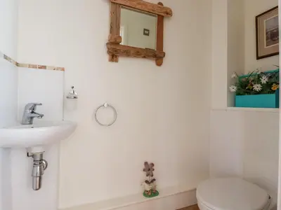 a bathroom with a sink and a toilet at 5 The Old Smokehouse in St Austell