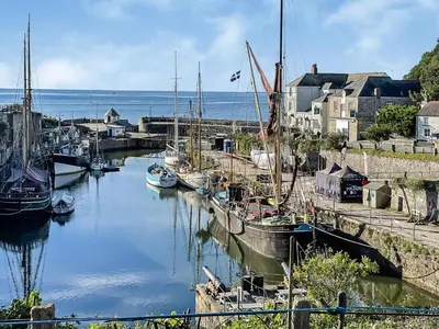 a group of boats are docked in a harbor at The Beach Retreat in Porth