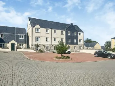 a large building with a car parked in front of it at The Beach Retreat in Porth