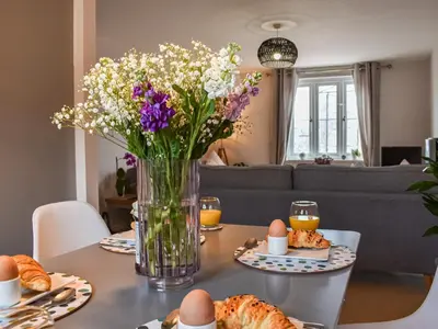 a vase of flowers sitting on a table with eggs at The Beach Retreat in Porth
