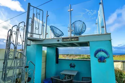 a building with a balcony with a sign that reads crooks nest at Finest Retreats - Treknow Summerhut in Tintagel