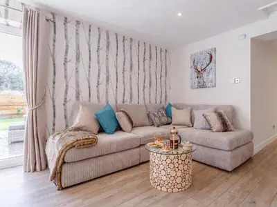 a living room with a couch and a table at 6 Bed in Penzance oc-77228 in Saint Hilary