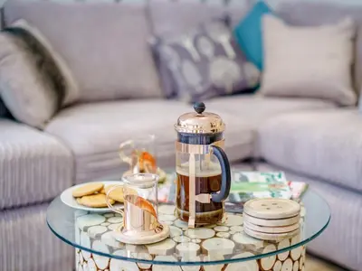 a coffee pot on a glass table in a living room at 6 Bed in Penzance oc-77228 in Saint Hilary
