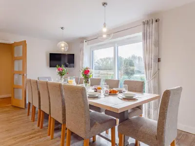 a dining room with a table and chairs and a window at 6 Bed in Penzance oc-77228 in Saint Hilary